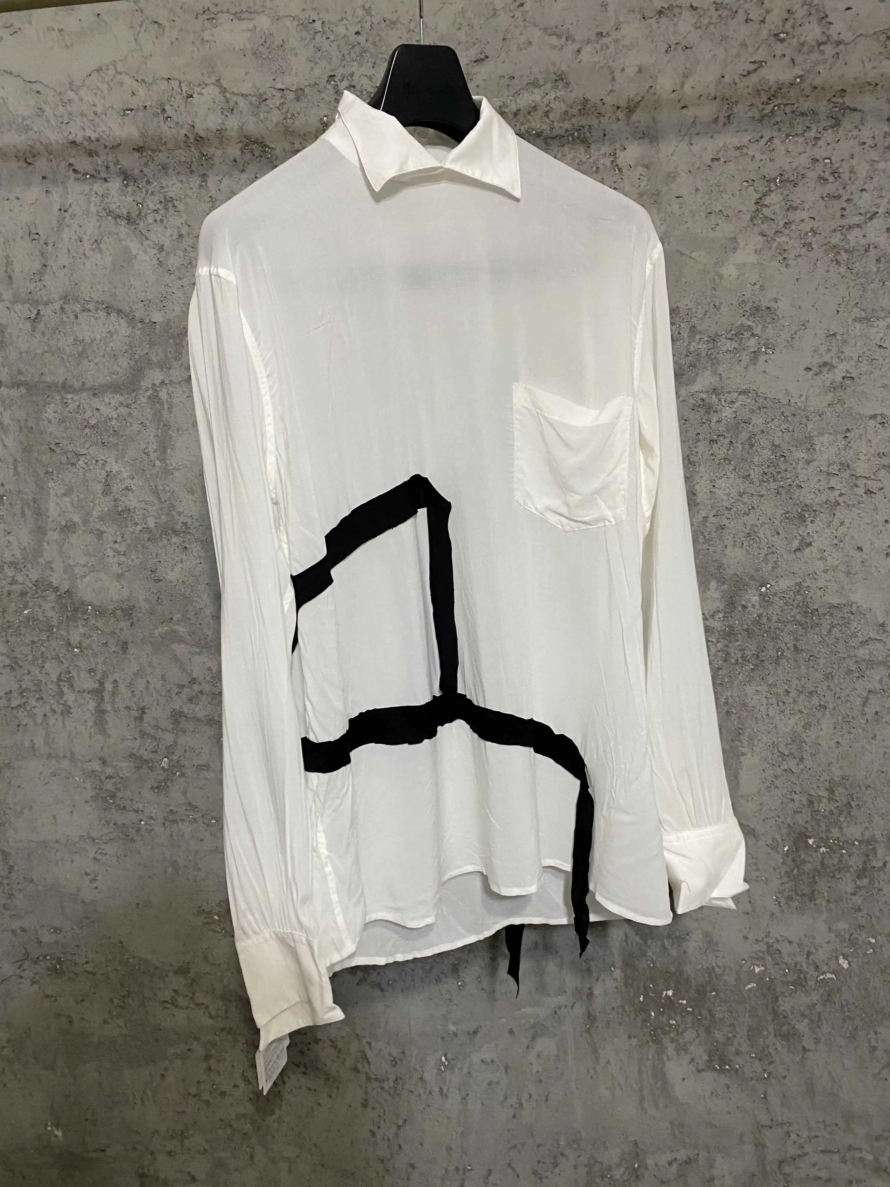 A black and white shirt with a slit ribbon on the back made of Japanese premium fabric