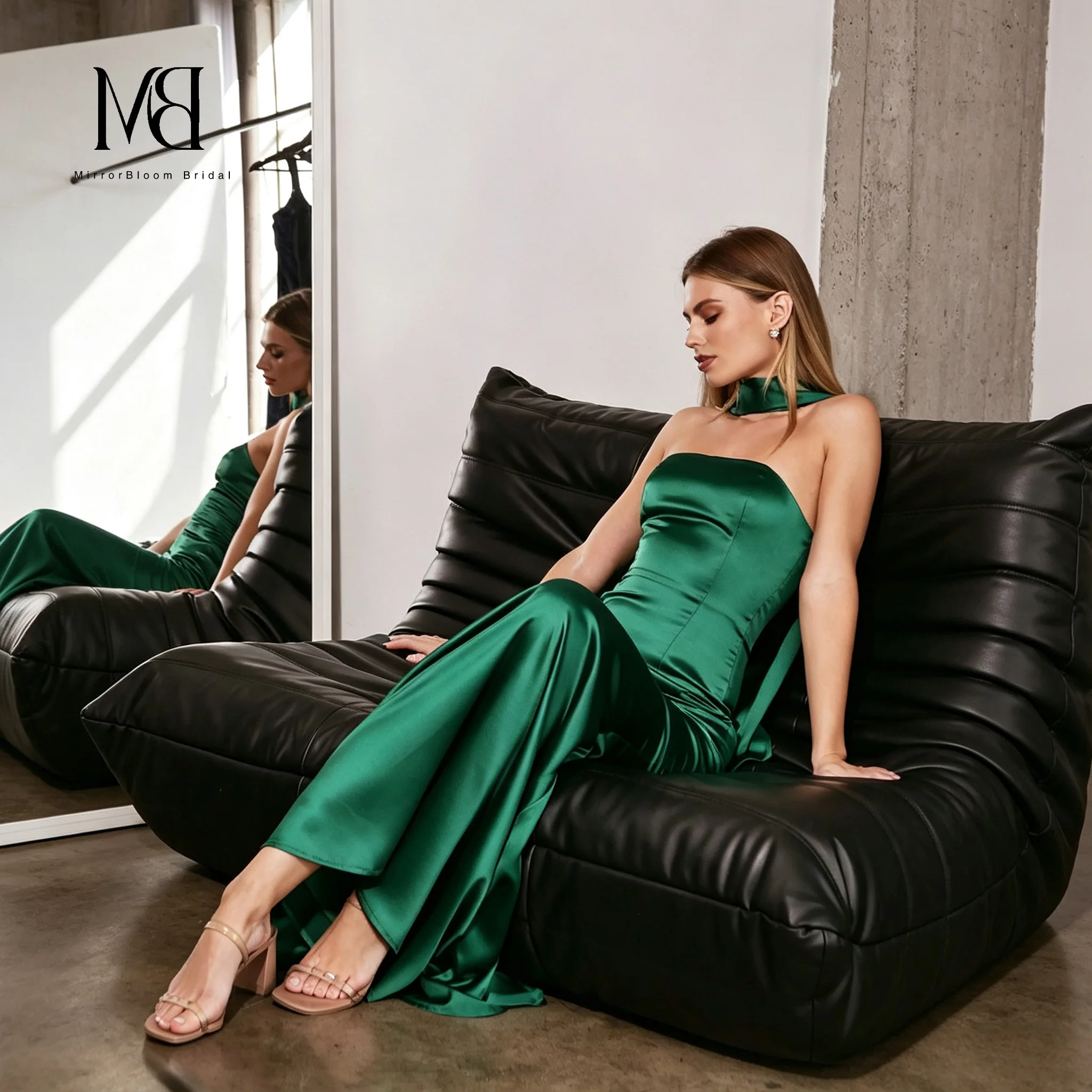 Green satin strapless sleeveless fish tail floor-length formal evening dress with flowing pleats and a draped neck ribbon