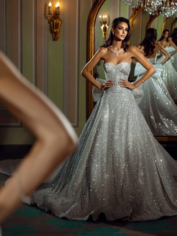 

Customized 2025 Strapless Sexy Luxury A-Line Strapless Brooch With Sparkling Sequins And Beaded Back Bow Wedding Dress
