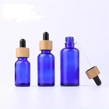 

5ml 10ml 15ml 20ml 30ml 50ml 100ml empty blue glass dropper bottle essential oil bottle packaging with bamboo top dropper