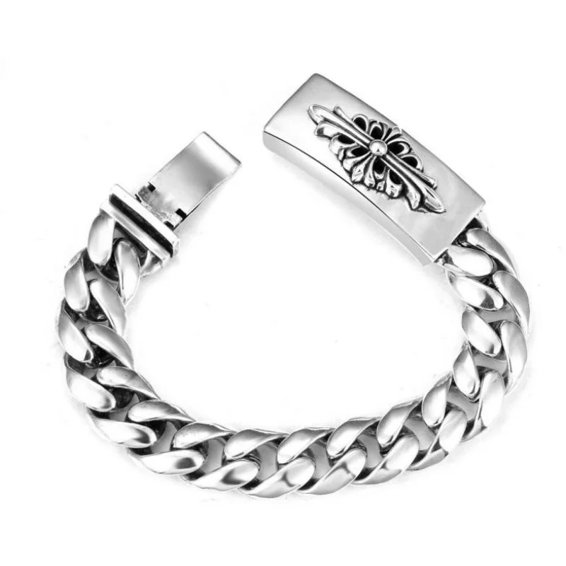 

Polished Silver Twisted Cuban Bracelet with Cross Flower Clasp: Sleek Statement Jewelry