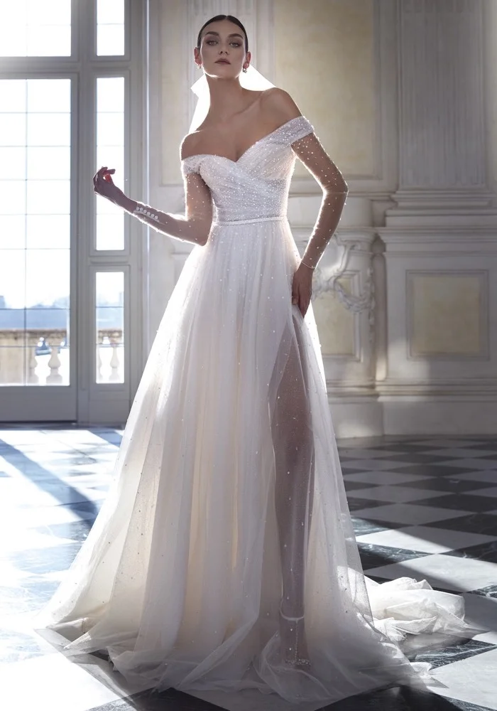 

Customized Luxurious White A-Line Sheer Pearl Women's Wedding Dress Sexy V-Neck Long Sleeved Side Slit Beach Dance Bridal Gown