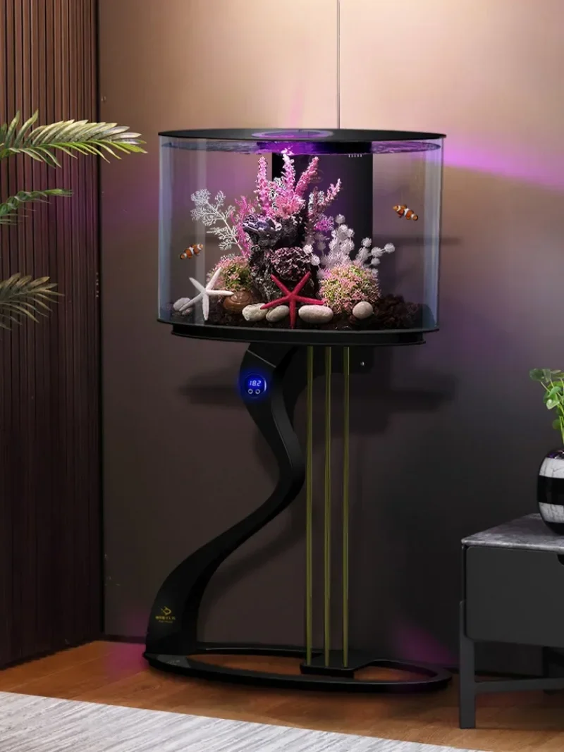 Floor-to-ceiling ecological fish tank next to  TV cabinet