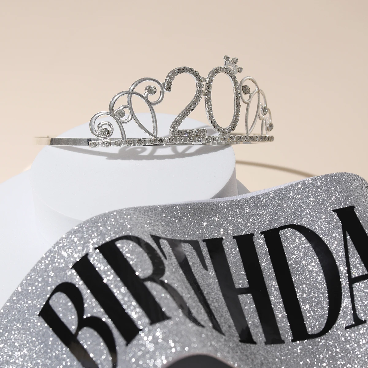 A classic 20 years old birthday themed digital crown paired with ribbons suitable for birthday event accessories