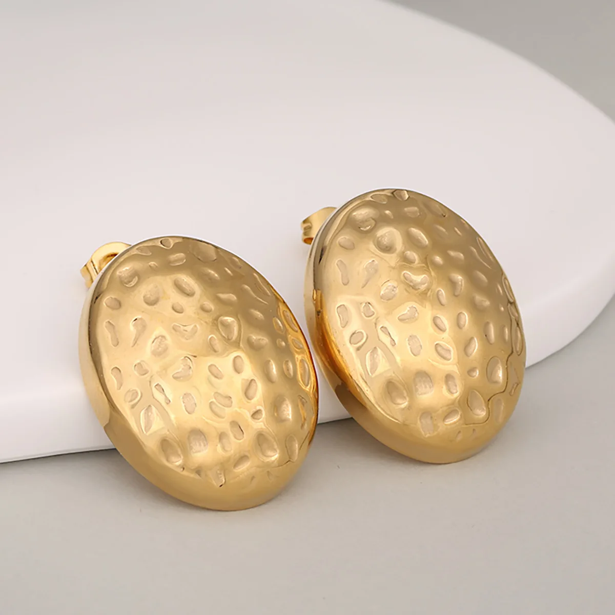 

Personal Unique Hammered Lava Stainless Steel Concave Convex Semi Oval Hollow Light Luxury Stud Earrings For Women