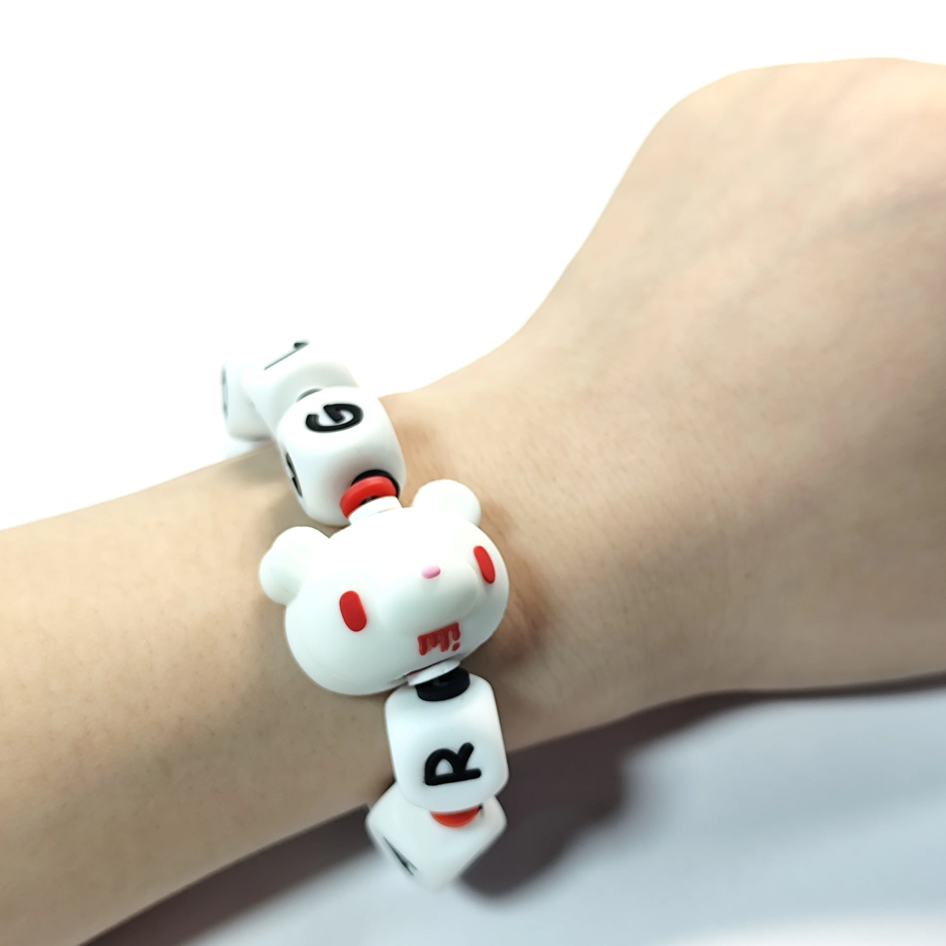 Fluorescent Gloomy Bear bracelet. White beads spell 