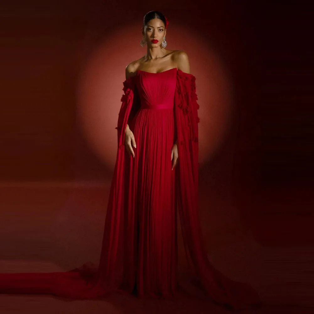 

Chic Red Gown With Pleated Design And Flowing Sleeves Features Bold Color And Dramatic Silhouette Highlighting Feminine Beaut