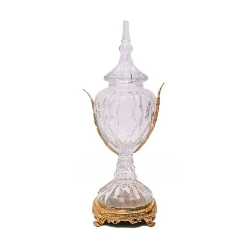 

Antique brass and glass vases with elegant decorative lids, intricately cut glass, and classic gold bases are suitable for