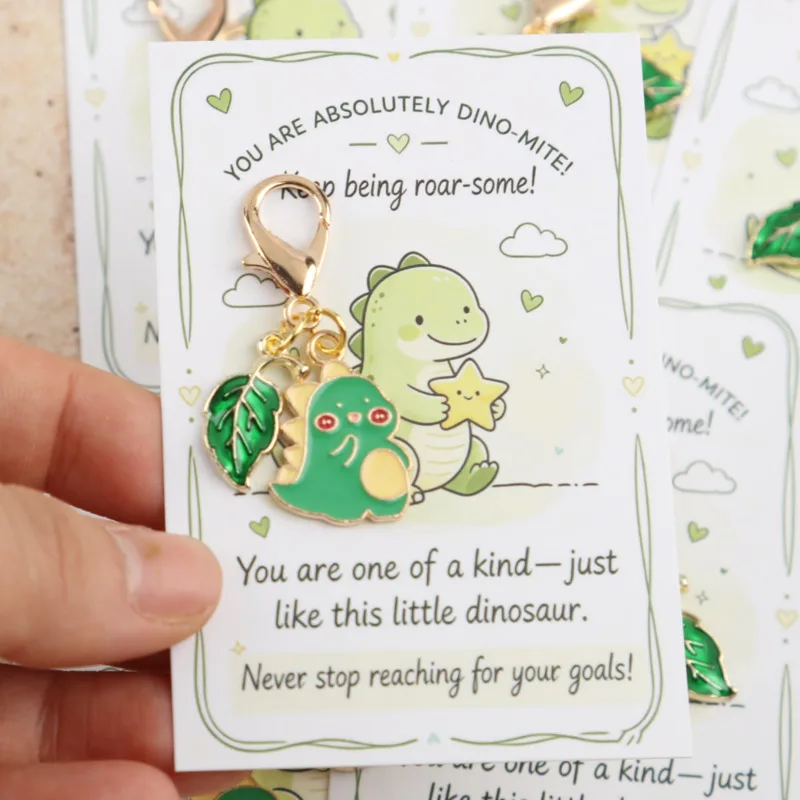 10/14pcs 2dGreen dinosaur keychain with leaf embellishments, perfect for decorating bags Comes with a cute dinosaur card Christm