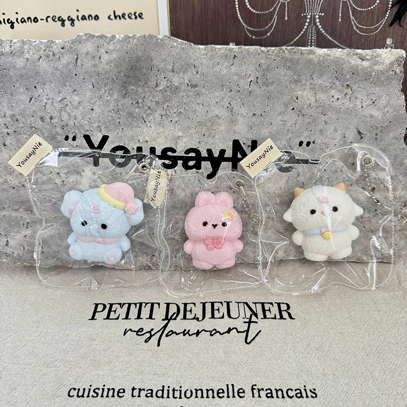 Slow-rising squishies in various animal shapes: a sheep wearing a bell, an elephant wearing a hat, and a bunny with a carrot hai