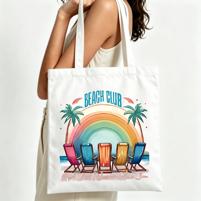 Women's beach club graphic canvas tote bag with rainbow and palm trees, perfect for summer beach outings and casual shopping