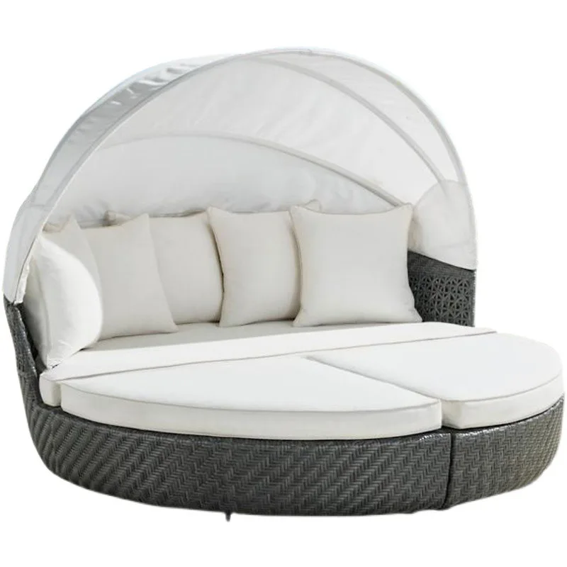 Rattan round bed open-air beach with waterproof sunscreen cover lying on the bed sofa shade
