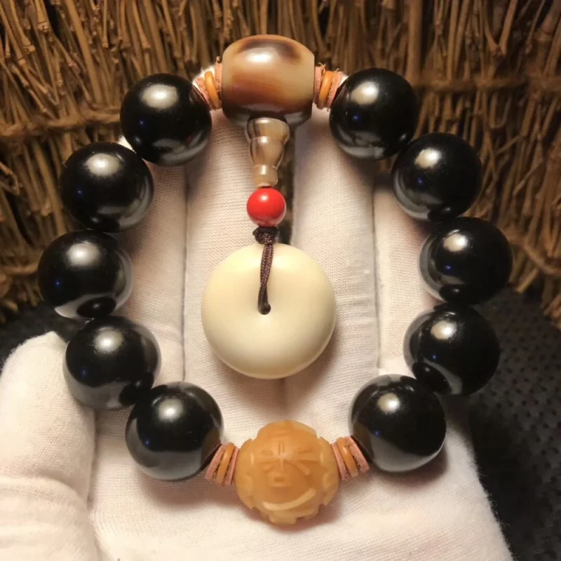 Natural black ox bracelet with weathered Bodhi beads, six-character mantra, ox horn connector, and ivory fruit peace pendan