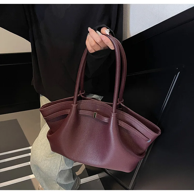 Bag worn crossbody on model in urban setting