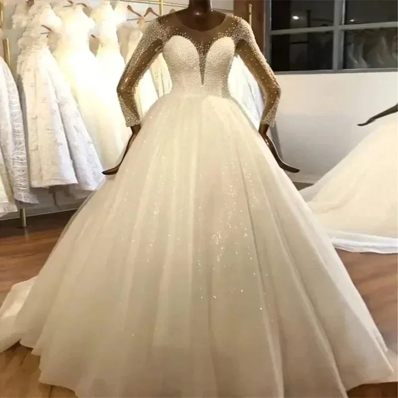 

Customized Scoop Neck Beads Pearls Ballgown Wedding Dress 2024 Vestido De Noiva Long Sleeves Ballgown Button Back Bridal Gowns