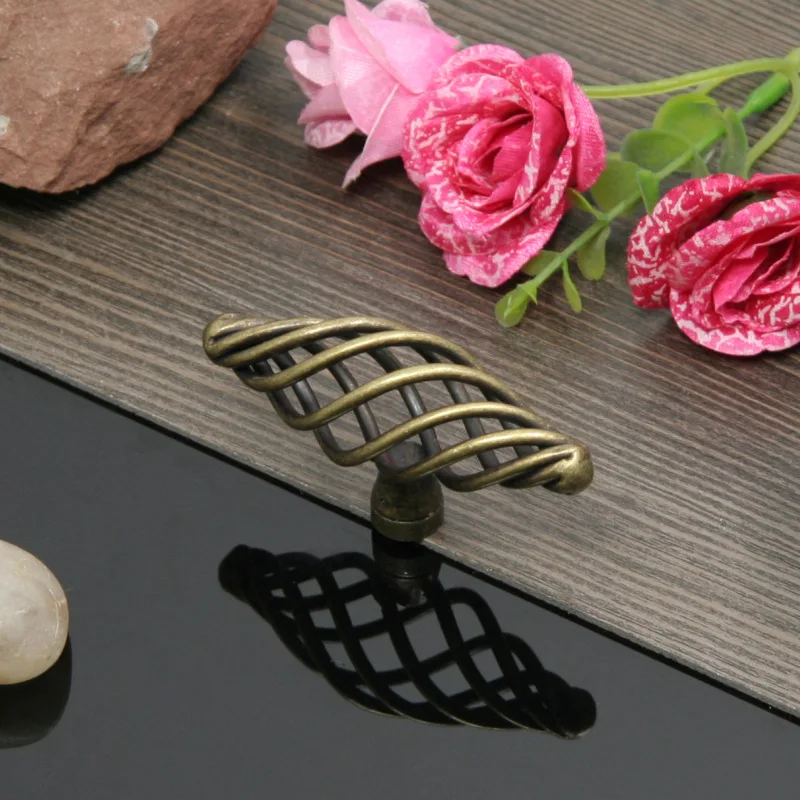 Furniture cabinet door handles in antique copper style. Shoe cabinet with drawers. Cabinet with single-hole hollowed-out Pulls
