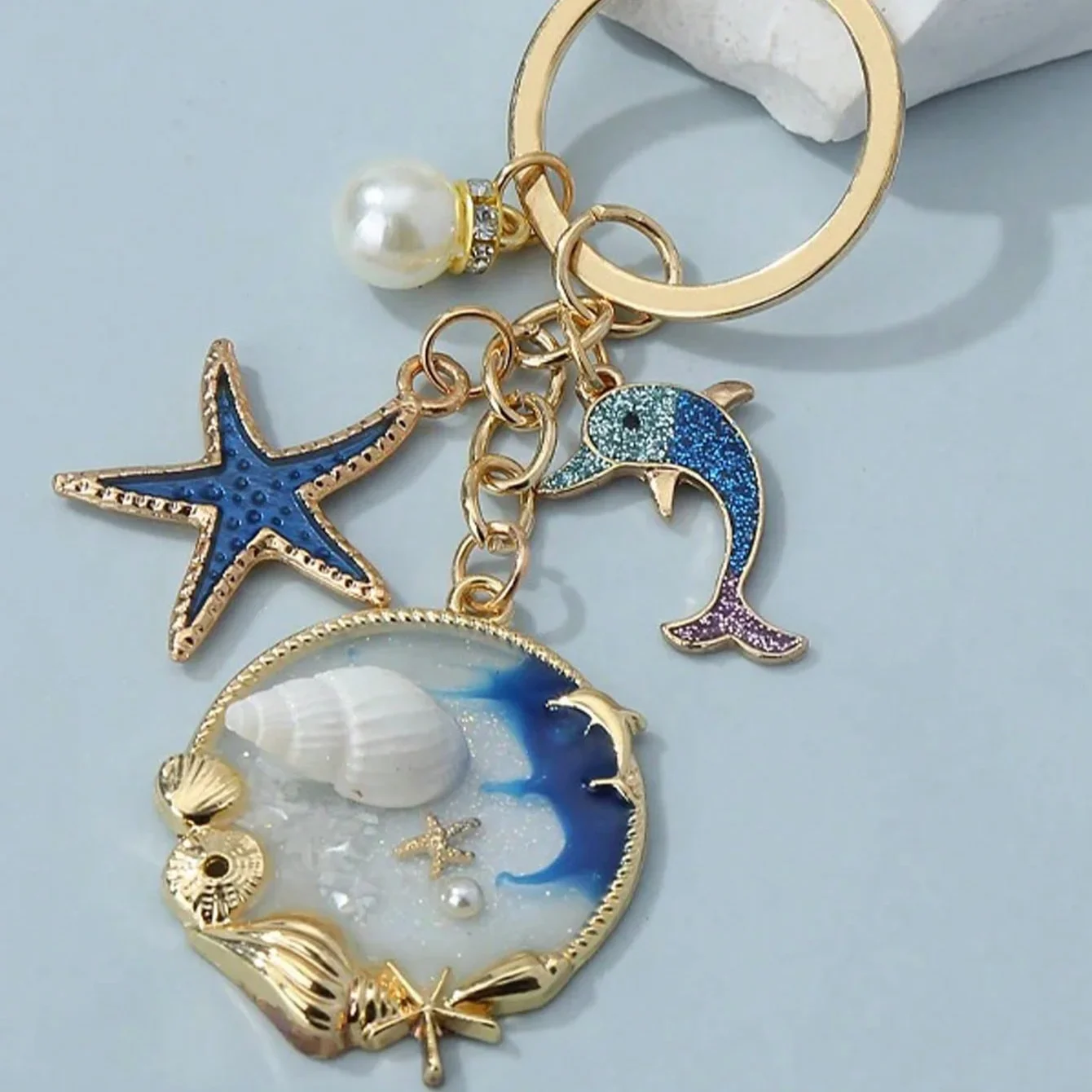 Llavero creativo con temática de océano azul, colgante de estrella de mar, delfín y concha, 1 ud.