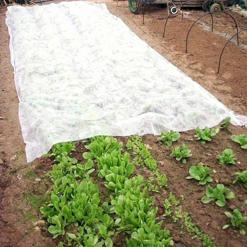 White non woven garden cover, easy to install and cut, promotes soil warmth and root development, reduces weed growth, durable a