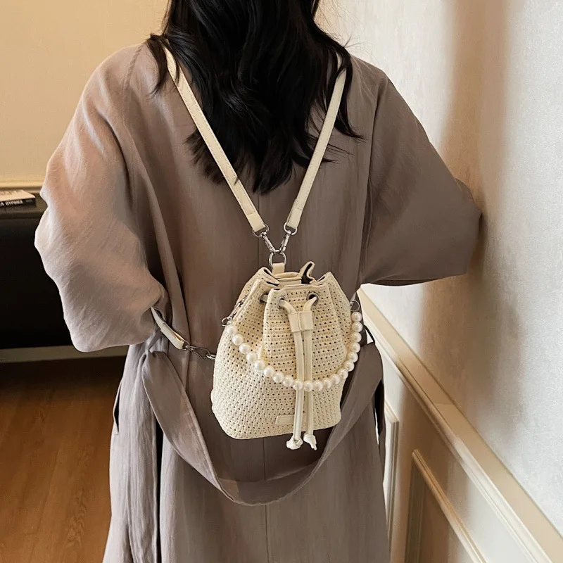 

Pearl hollow bucket woven bag women's vacation new handheld shoulder messenger bag beach bag foreign style backpack