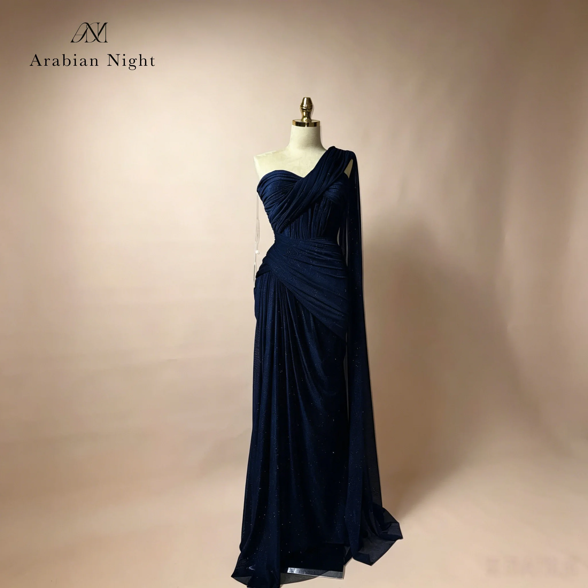 

Elegant blue strapless sleeveless floor-length mermaid evening gown with a long shawl on one side, exuding sophistication.