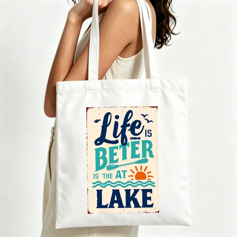 Women's lake-themed canvas tote bag with vintage typography print, ideal for summer outings and casual daily use