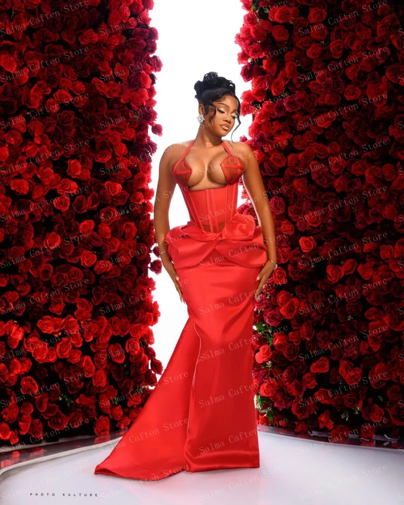 Elegant Red Gown With Structured Bustier And Flowing Skirt Features Bold Waist Tie And Sleek Silhouette Highlighting Feminine Cu