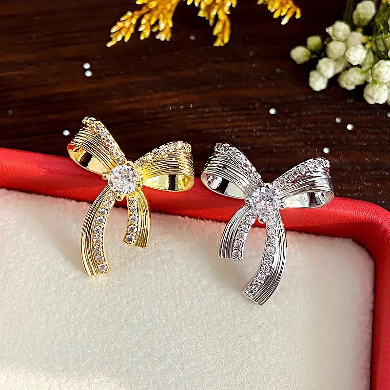 Exquisite Bow Micro Inlaid Zircon Asymmetrical Personality Fashionable Light Luxury Niche Design Earrings for Women.