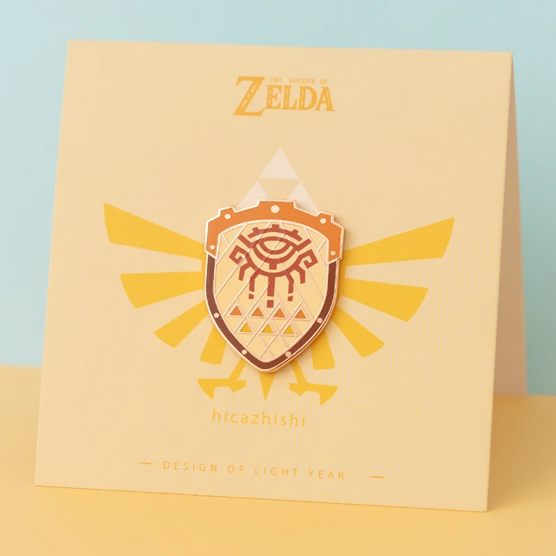 アニメバッジゼルダのハイリアの盾ピンブローチムジュラのマスクマスターソードバッジブローチラペルピンジーンズシャツバッグジュエリーギフト