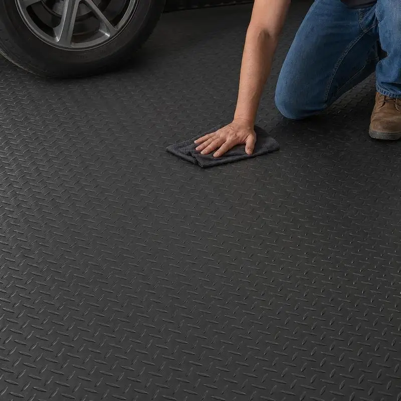 2 Rolls of Heavy Black Diamond Textured Flooring, Located on The Surface of The Basement of The Gym in The Car Storage Area
