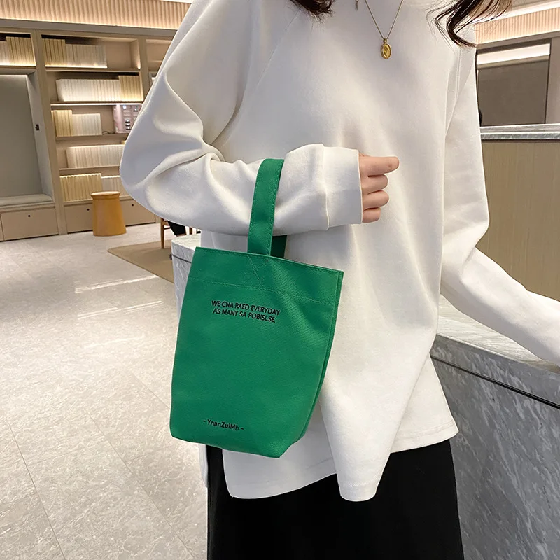 2023 new minimalist style mini portable canvas bag lunch bag candy color kettle wrist strap plain canvas bag