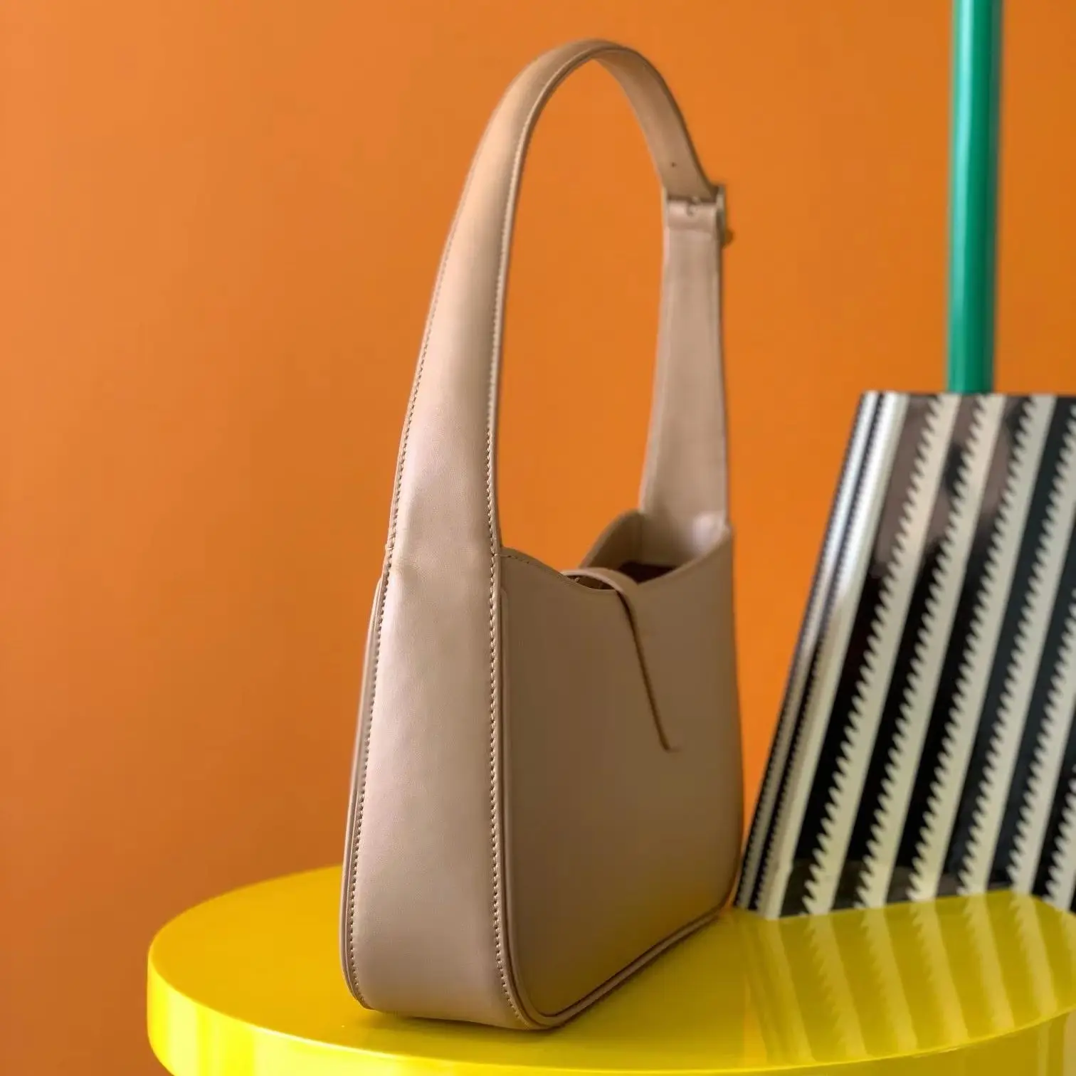 

Camel-colored crossbody bag, smooth shiny leather, neat fully stitched edges, no extra metal hardware.