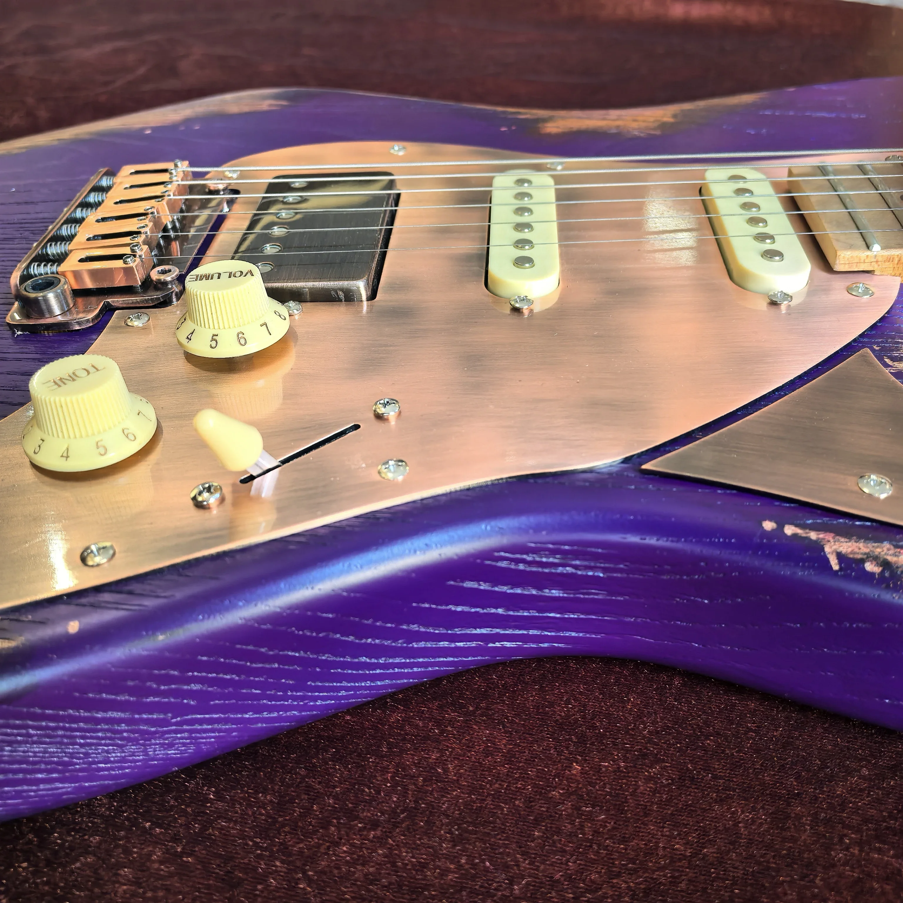 Make an old-style 6-string electric guitar. Purple color. Locking tuning pegs. Aluminum-nickel-cobalt pickups.  Customizable!