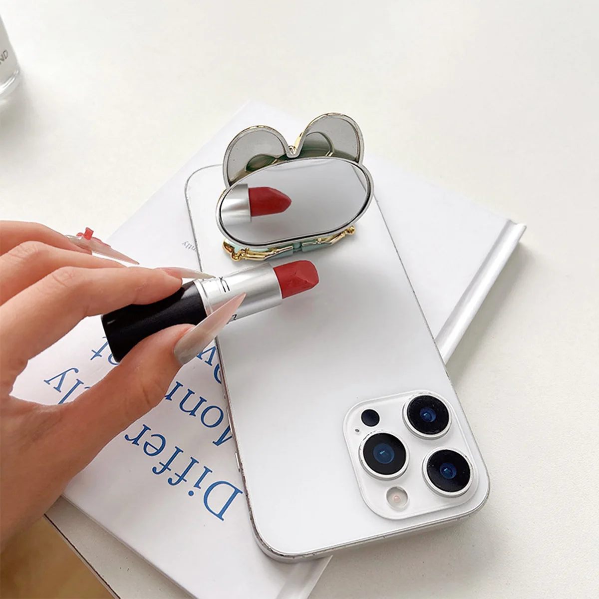 Un soporte para teléfono galvanizado reversible en forma de conejo con espejo y soporte para teléfono