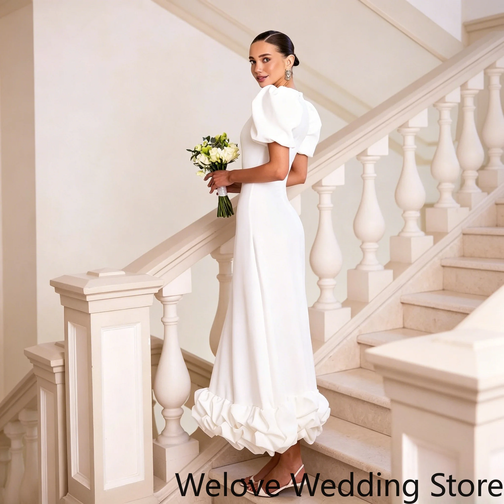 Elegant White Modern Wedding Dress featuring voluminous puff sleeves, a sleek fitted bodice, and a unique ruffled hem