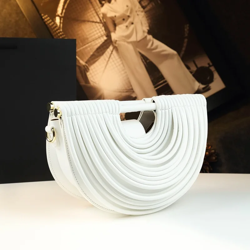 Unique three-dimensional striped semi-circular handbag, equipped with a detachable shoulder strap, is a multifunctional women's