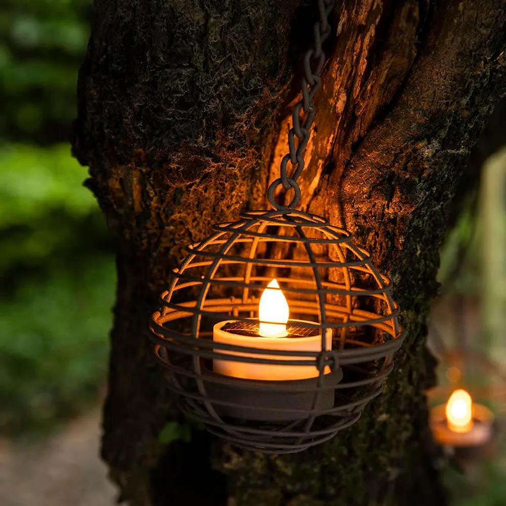 Close-up of rust iron ball solar lantern showing intricate filigree metalwork