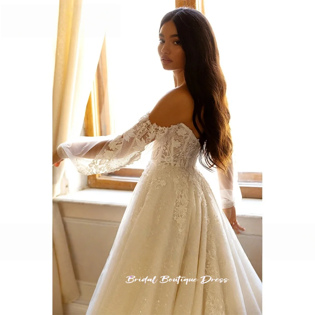 カスタマイズされたエレガントなAラインのウェディングドレスビーズレースアップリケ花嫁恋人バックレスパフスリーブプリンセスブライダルドレストレーン