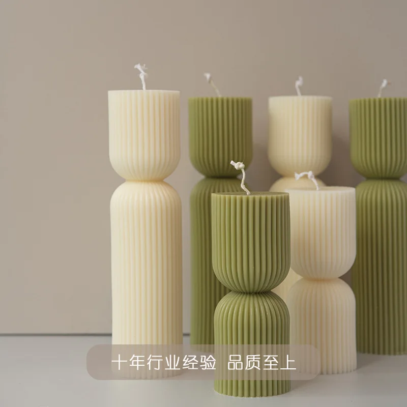 Handmade scented candles with striped columns. White and green decoration. Blue wind chimes scented candles accompanied the cere