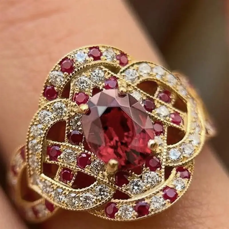 Huitan Luxus-Ring für Damen in Goldfarbe, wunderschöner Hochzeits- und Verlobungsring, elegantes Accessoire mit glänzendem rotem ovalem CZ, Modeschmuck