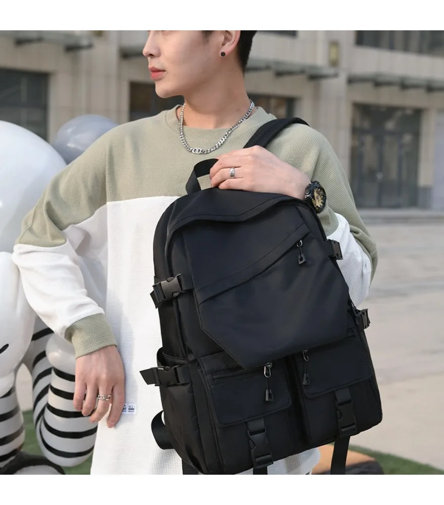 Black diagonal flap multi pocket backpack anti splash wear resistant fabric for daily short outdoor journeys