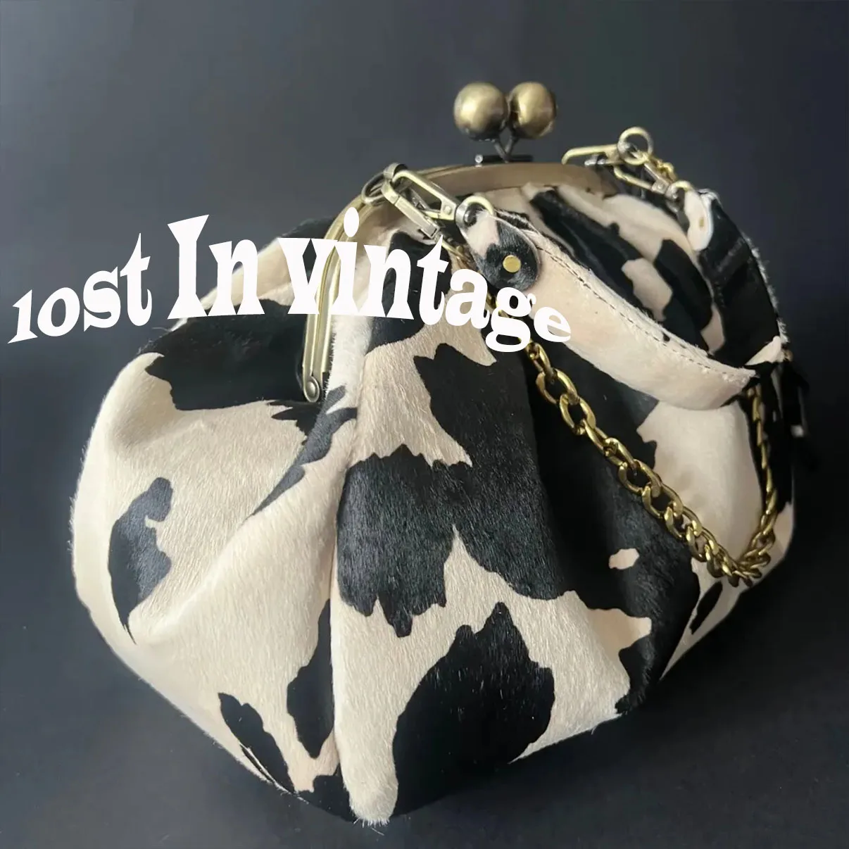

LOST IN VINTAGE Leather Cow Pattern Fabric Clutch Metal Frame Kiss Lock and Metal Handle Puffy Purse 34x23x11cm Cow Soft Fabric