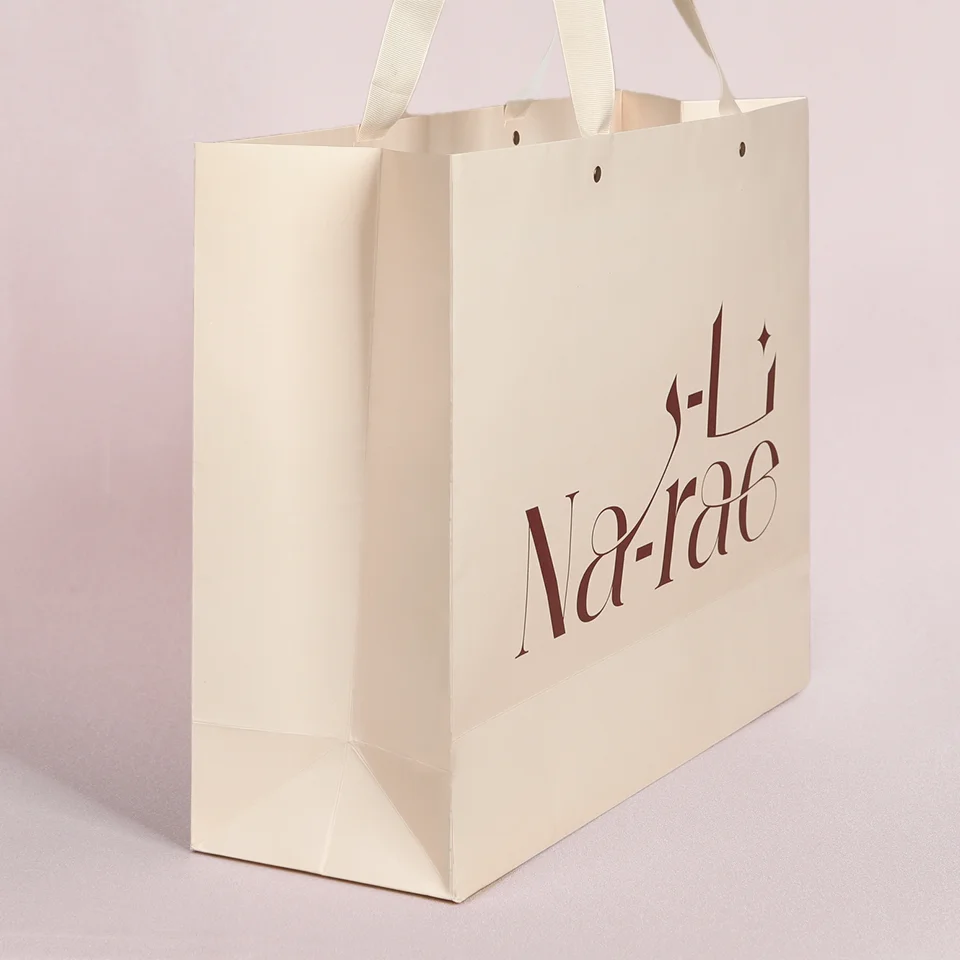 Custom Recycled  Luxury Cream Beige Shopping Paper Bags With Your Own Logo Ivory Clothes Packaging Gift Bag With Ribbon Handle