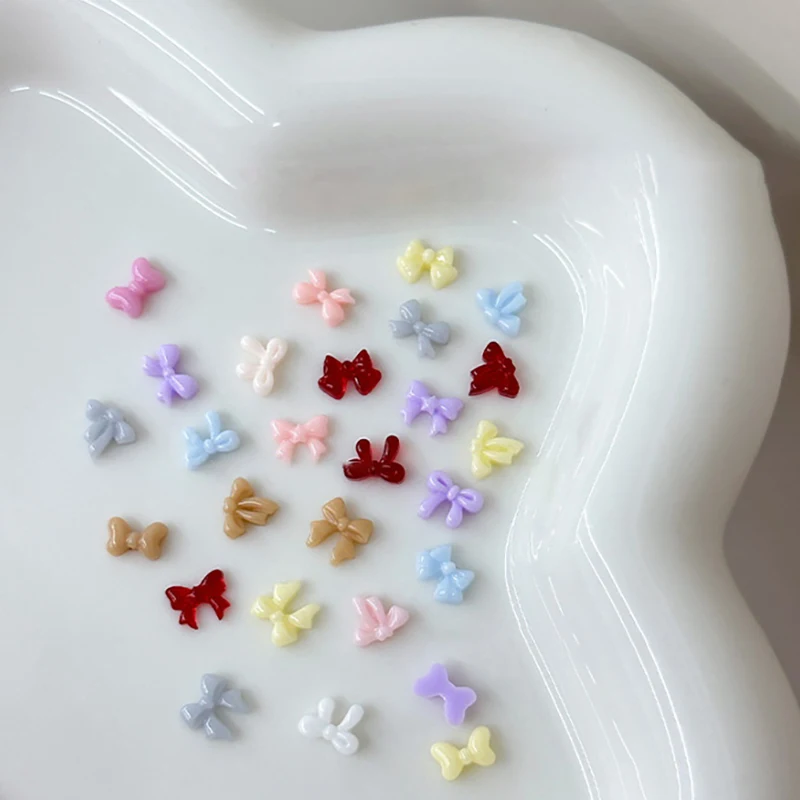 100 ชิ้น Mini Bow ตกแต่งเล็บใหม่ Candy สีเรซิ่นริบบิ้นผสมเครื่องประดับเจาะเล็บอุปกรณ์เสริม