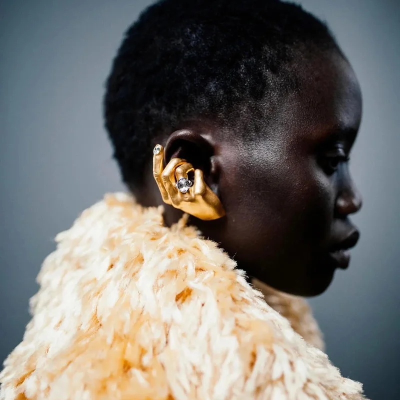 Retro-chic, subtly luxurious, niche, uniquely designed hand gesture earrings for those without pierced ears; vacation jewelry