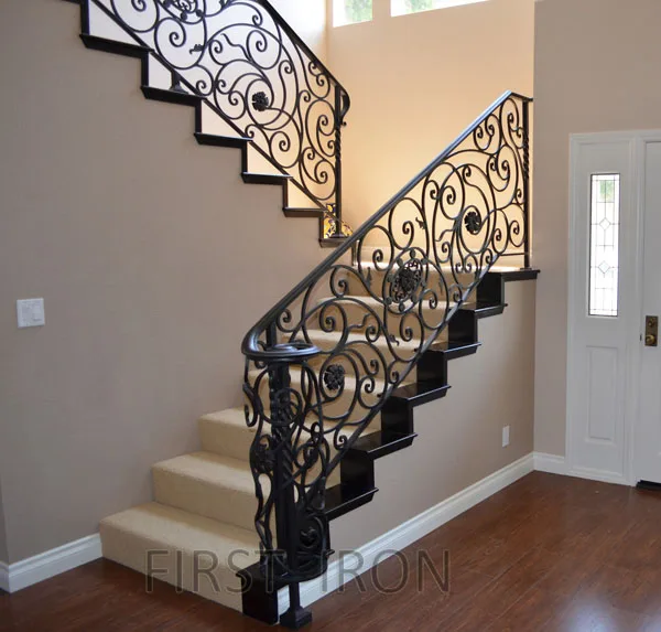 Antique wrought iron indoor staircase balustrade with wooden handrail