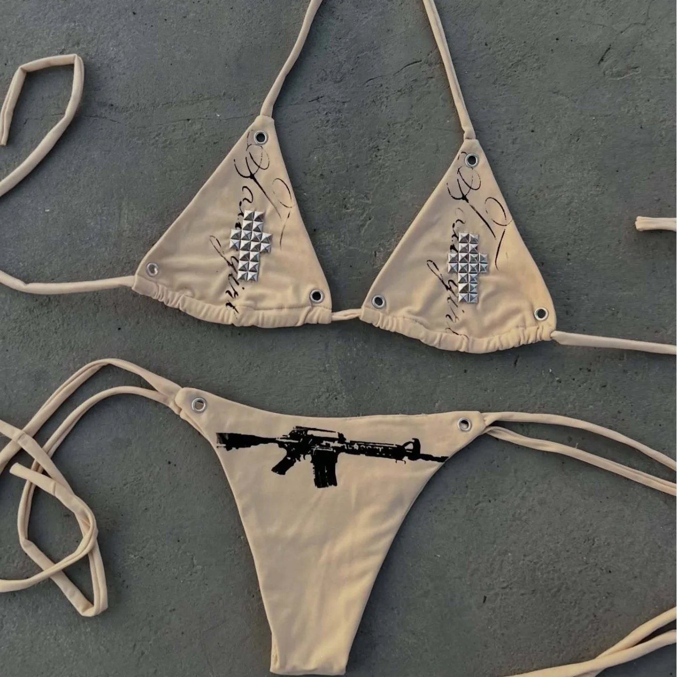 Dark style studded bikini set with triangular hanging neck and gun print strap swimsuit