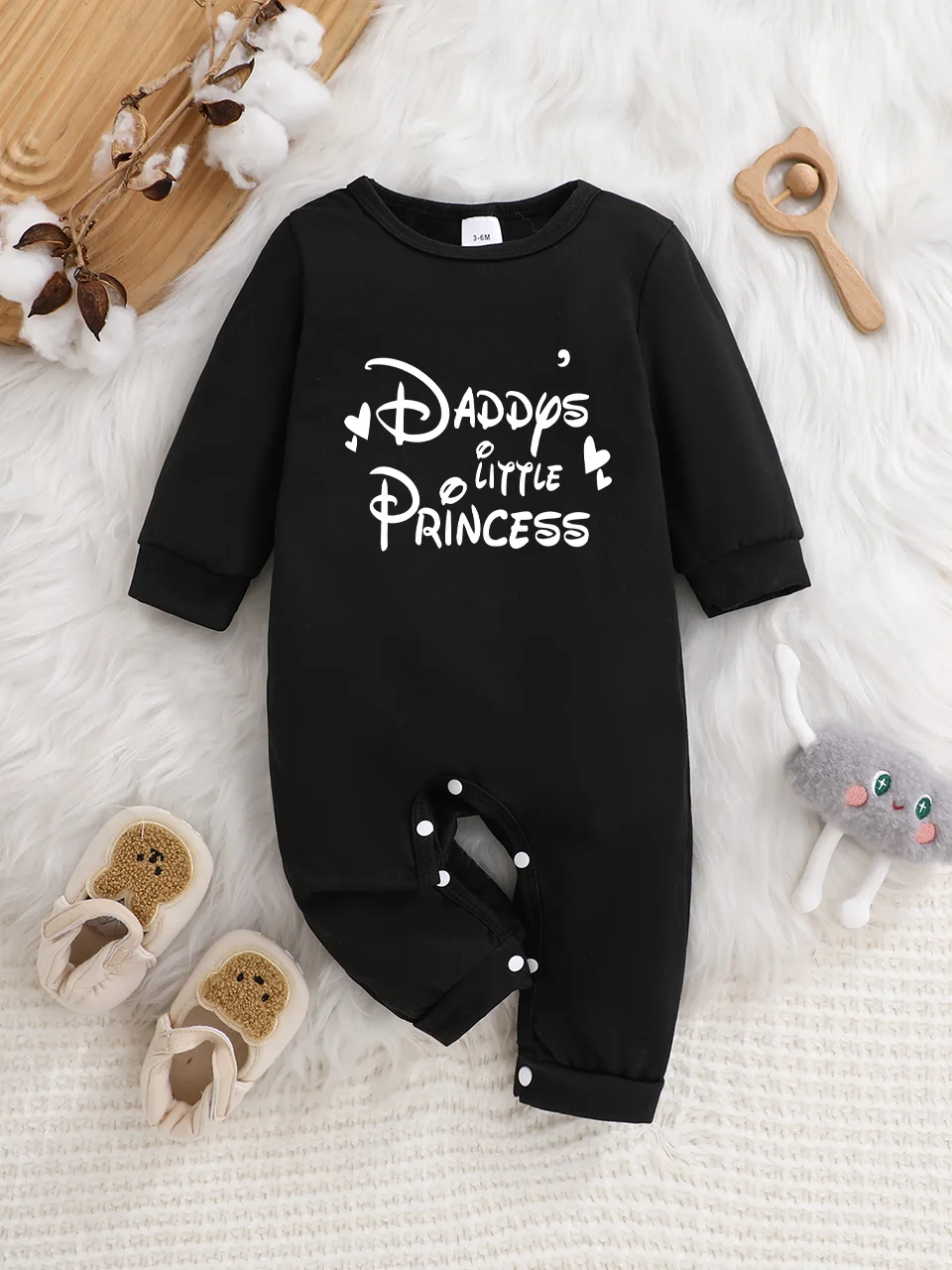 Baby long-sleeved bodysuit with fun letter prints, button design, easy care, suitable for new parents.