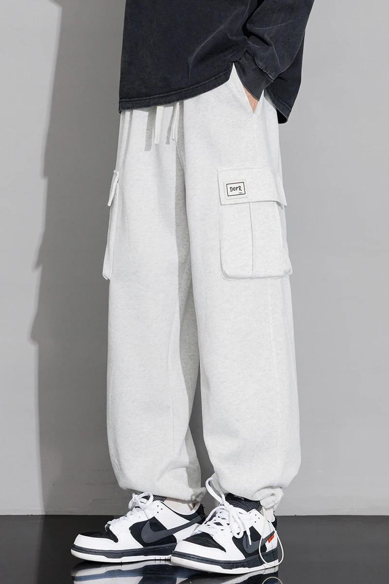 Męskie spodnie dresowe o prostym kroju, typu joggers, do sportu i streetwearu, luźne, oversize'owe, z długimi nogawkami, ze sznurkiem, męskie spodnie z wieloma kieszeniami.