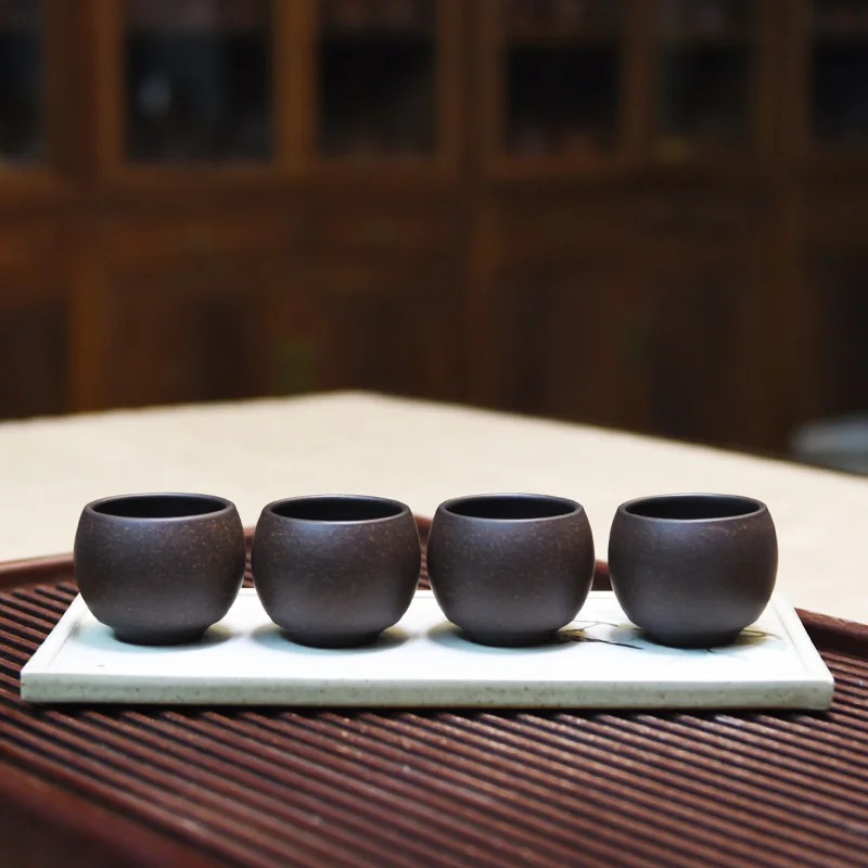 

A group of 4 Yixing purple sand tea cup small cup tea set purple mud