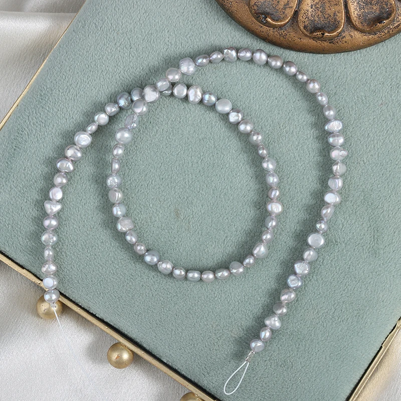 Approximately 80 irregularly shaped, two-sided polished gray Baroque freshwater pearls without nuclei, measuring 4-5mm each.